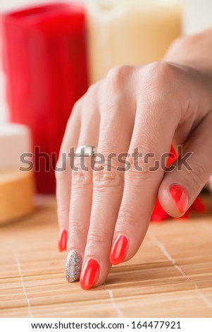 Manicure - Beauty treatment photo of nice manicured woman fingernails with red nail polish. Selective focus.