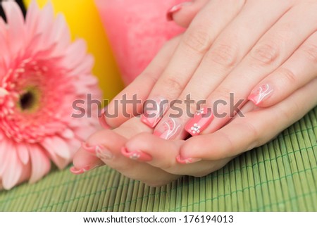 Manicure - Beauty treatment photo of nice manicured woman fingernails. Very interesting nail art with nice pink and white nail polish. Selective focus.