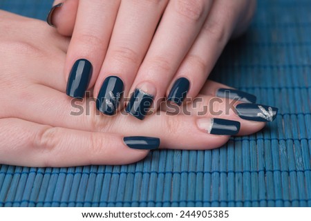 Manicure - Beauty treatment photo of nice manicured woman fingernails. Very nice  nail art with petroleum blue nail polish. Selective focus.
