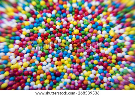 Macro of Sugar colorful balls powder background