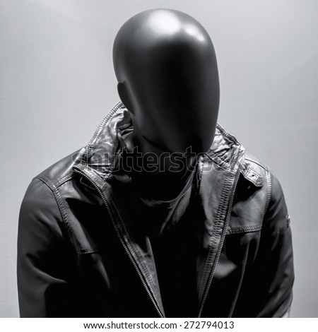 Fashion mannequin in black leather coat over dark grey background. Black White