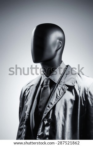 Fashion mannequin in suit over dark grey background. Black White photo
