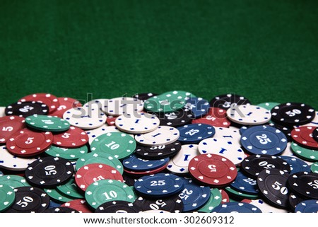 Casino chips on a green table background