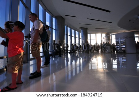 DUBAI, UAE - CIRCA JANUARY 2014: People watching the Dubai skyline from the observation deck in the tallest building in the world, Burj Khalifa, at 828m, taken circa January 2014 in Dubai.