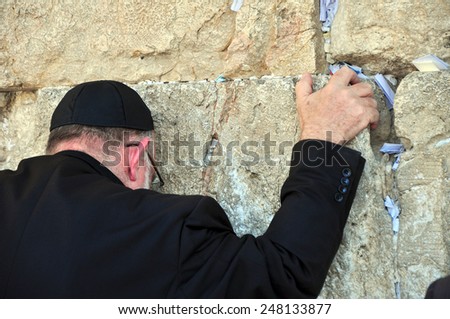 JERUSALEM, ISRAEL - circa August 2014: A hassidic Jew prays at the wailing wall in the Old City circa August 2014 in Jerusalem, Israel. The wall is is one of the most sacred sites in Judaism.
