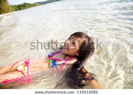 Asian little girl swimming in sea
