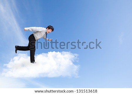 Young business man running on cloud over sky, Business concept