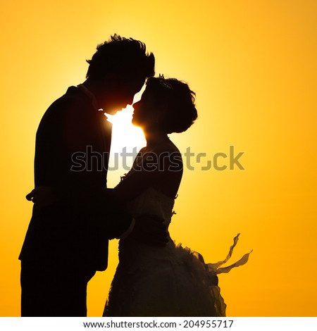 Silhouette couple love with sunset