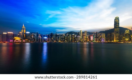 Hong kong city skyline at night over victoria harbour with clear sky and urban skyscrapers