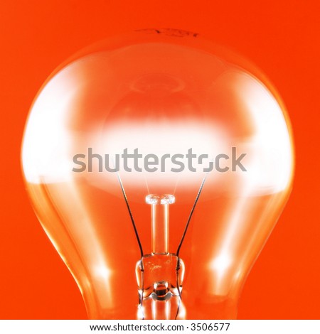 close-up of a glowing light bulb on a red background