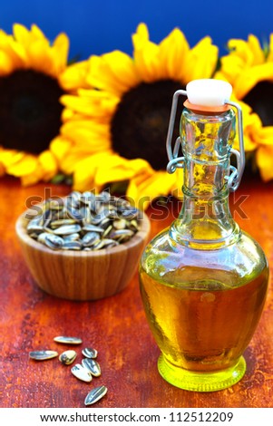 Bottle of sunflowers  oil on a colorful wooden background with sunflowers seeds