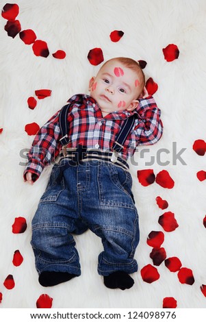 Dumbfounded cute boy with lipstick on his face. Greeting card for valentines day.