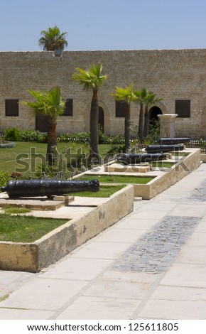 Line of cannons in the entrance yard of the Citadel of Qaitbay surrounding the main entrance to the front gate