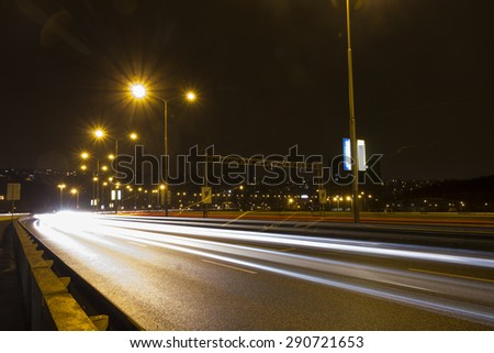Car light streaks on a bridge over Vltava river in Prague at night