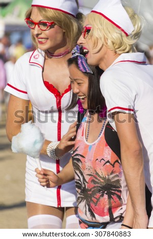 PRAGUE - AUGUST 15, 2015: Two men dressed as sexy female nurses at Letna park on the fifth Gay Prague Pride 2015
