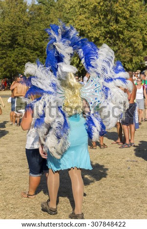 PRAGUE - AUGUST 15, 2015: A man dressed as a blue drag queen with feathers at Letna park on the fifth Gay Prague Pride 2015