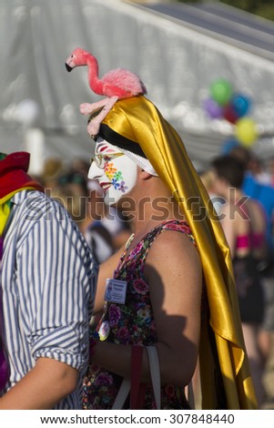 PRAGUE - AUGUST 15, 2015: An older man at Letna park being dressed as a drag queen and taking photos with others at the fifth Gay Prague Pride 2015
