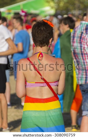 PRAGUE - AUGUST 15, 2015: A woman in a rainbow dress on the fifth Prague Pride 2015 with up to 35,000 people marching through the city to Letna park where a large outdoor music festival happened.