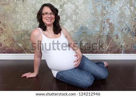 Beautiful pregnant woman 8 months along in studio