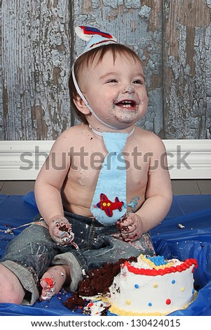 Infant boy\'s first birthday cake smash Adorable baby smashing cake