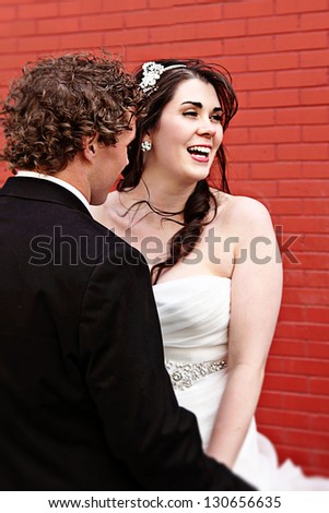 Bride and Groom on wedding Day - Red Brick wall as background
