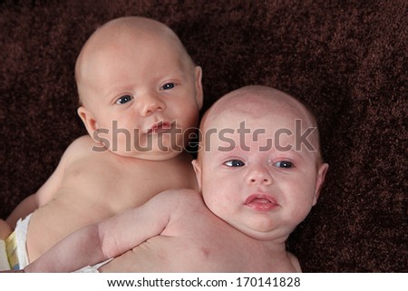 Adorable little brother and Sister twins on studio background
