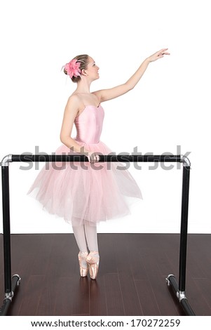 Ballerina dancing in studio with white background