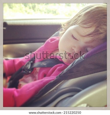 Sweet baby girl sleeping in car seat - instagram effect