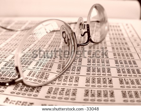 Pair of professional glasses on a business book with sepia tone