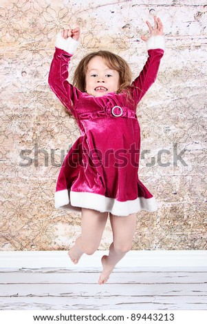 Little Girl Jumping with Christmas dress on