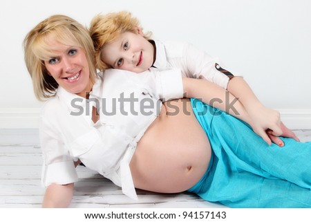 Pregnant woman at 8 months on white