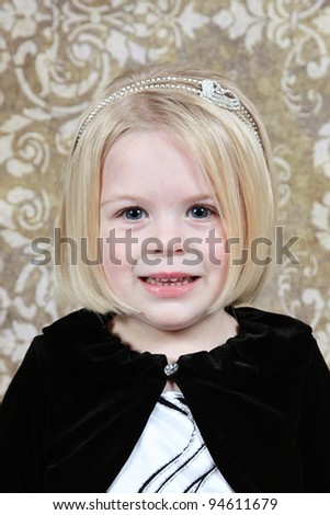 Cute little girl in studio posing for the camera