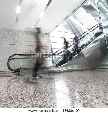 Man move in glass corridor in airport