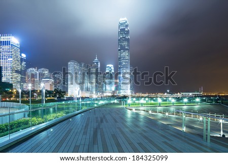 pathway in the night with modern city background