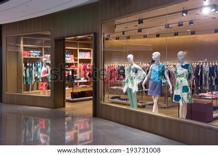 Boutique display window with mannequins in fashionable dresses