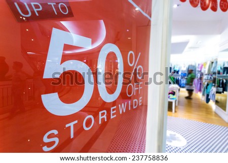 clothes storefront window with discount poster