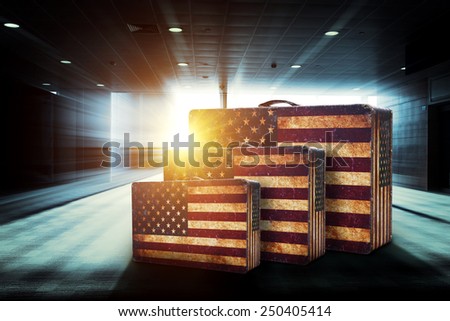 usa flag pattern luggage in airport corridor with abstract background