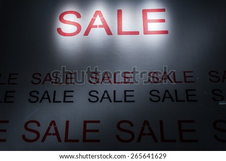 sale poster light up in fashion shop display window