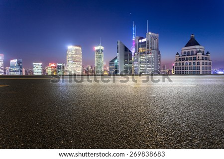 urban road,illuminated skyline background