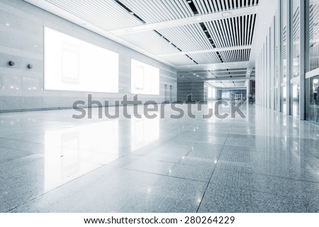 empty billboard and floor in shopping mall corridor