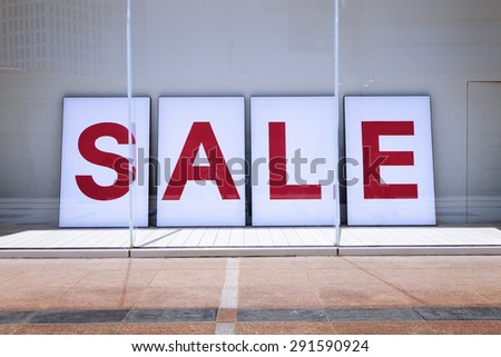 sale poster in shop display window