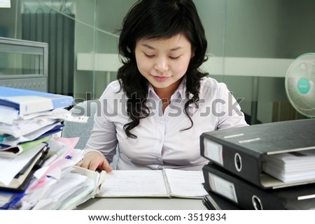 Young businesswomen reads a printed document
