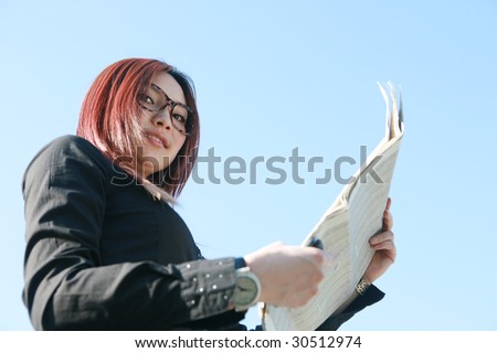 young asian businesswoman reading newspaper
