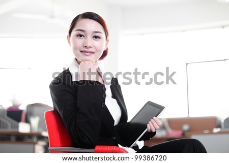 business woman holding tablet sitting on chair