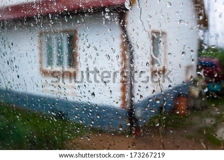 HOUSE VIEW FROM TRAIN WINDOW BY RAIN