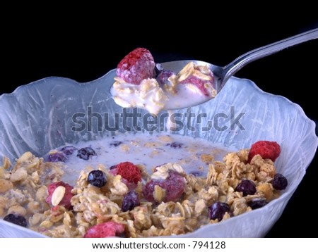 bowl of cereal with milk dripping off spoon