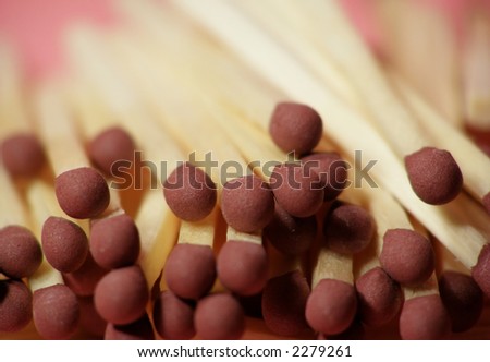 Close-up of group of matches on pink background