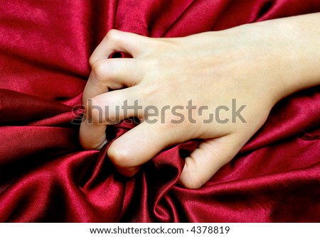 woman\'s hand holding a satin sheet, a moment of pleasure