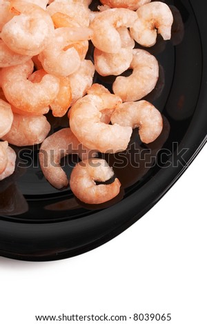 frozen shrimps on a black plate