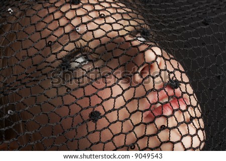 mysterious girl with blue eyes wearing black veil